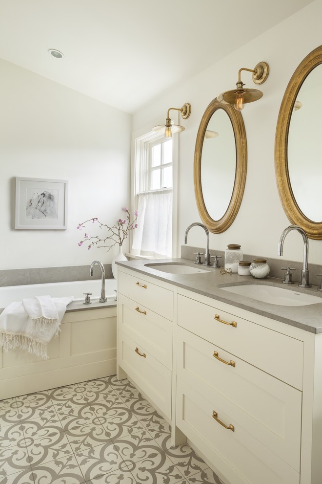 Design ideas for a transitional bathroom in Vancouver with white cabinets, white walls and a drop-in tub.