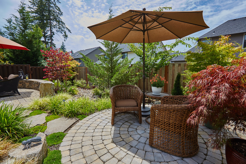 Photo of a traditional backyard patio in Portland with concrete pavers.