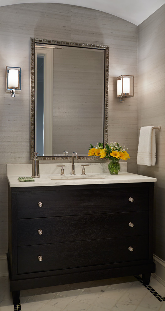 Transitional powder room in Chicago with dark wood cabinets, marble floors, marble benchtops and white benchtops.
