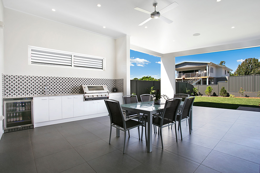 Inspiration for a large contemporary backyard patio in Brisbane with an outdoor kitchen and tile.