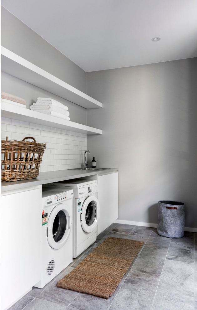 This is an example of a mid-sized contemporary galley laundry room in Sydney.