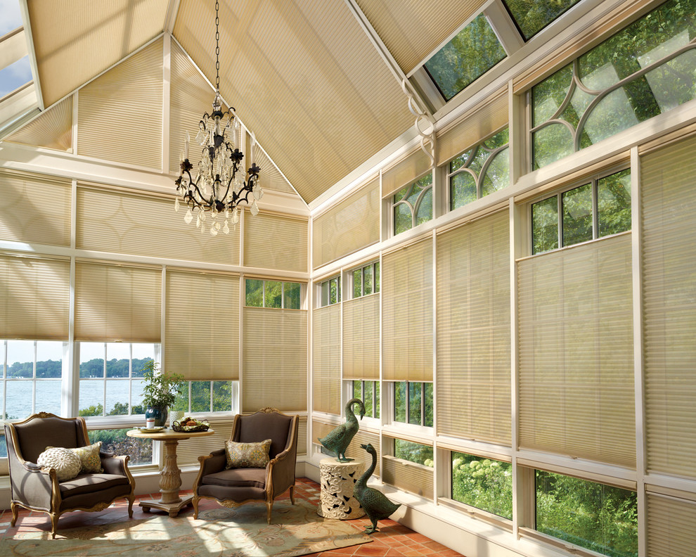 Photo of a large tropical sunroom in Tampa with terra-cotta floors and a glass ceiling.