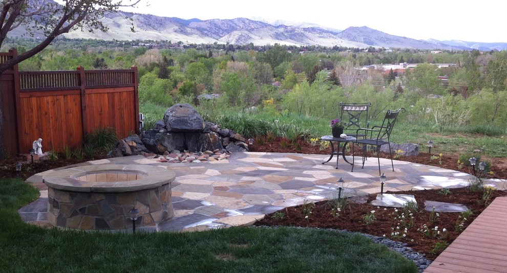 Mid-sized eclectic backyard patio in Denver with a fire feature, natural stone pavers and no cover.