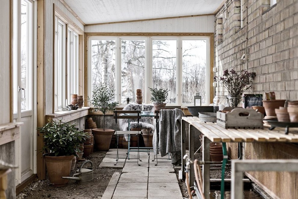 Photo of a scandinavian sunroom in Stockholm with no fireplace and a standard ceiling.