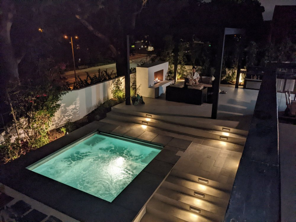 Inspiration for a contemporary backyard tile hot tub remodel in Orange County