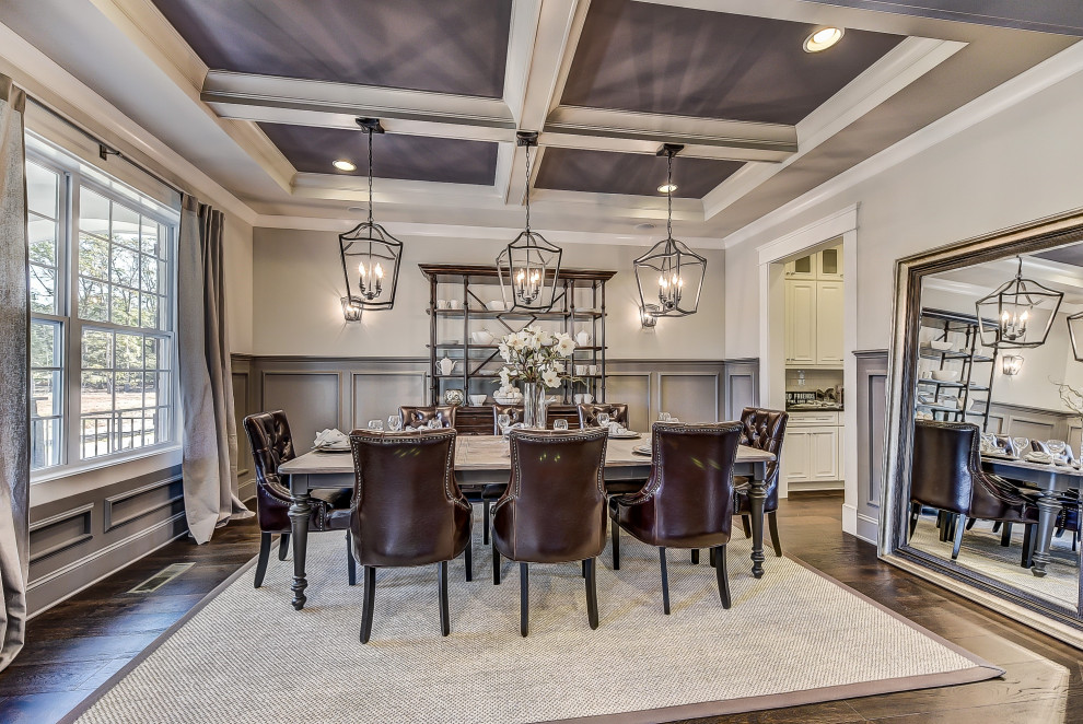 Inspiration for a large transitional dining room in Charlotte with beige walls, dark hardwood floors, coffered and decorative wall panelling.