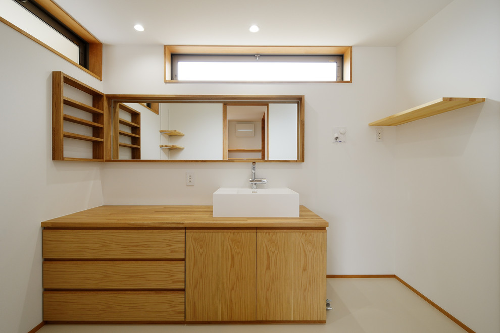 Photo of a medium sized scandi cloakroom in Other with flat-panel cabinets, medium wood cabinets, white walls, vinyl flooring, a vessel sink, wooden worktops, beige floors, brown worktops, a built in vanity unit, a wallpapered ceiling and wallpapered walls.