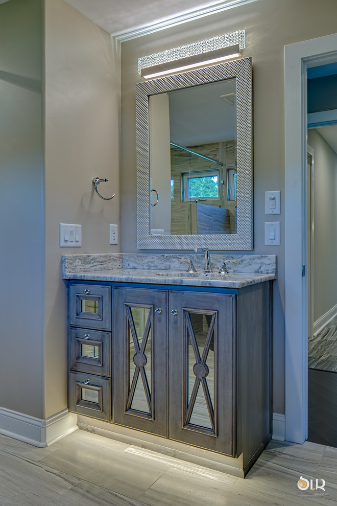 Example of a transitional master dark wood floor and beige floor freestanding bathtub design with flat-panel cabinets, light wood cabinets and gray walls