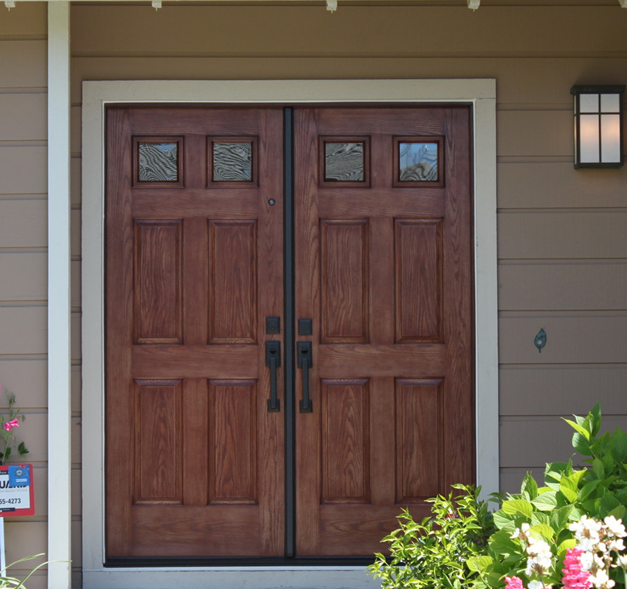 Inspiration for a traditional entryway in San Francisco with a double front door and a dark wood front door.