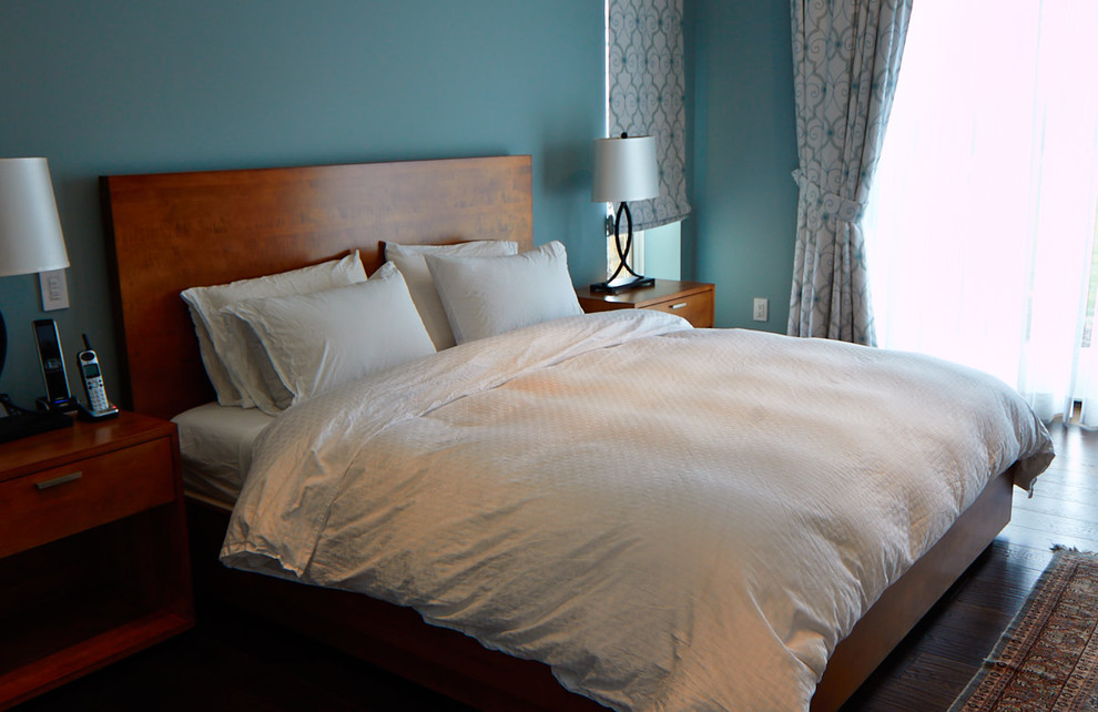 Design ideas for a transitional bedroom in Toronto with blue walls and dark hardwood floors.
