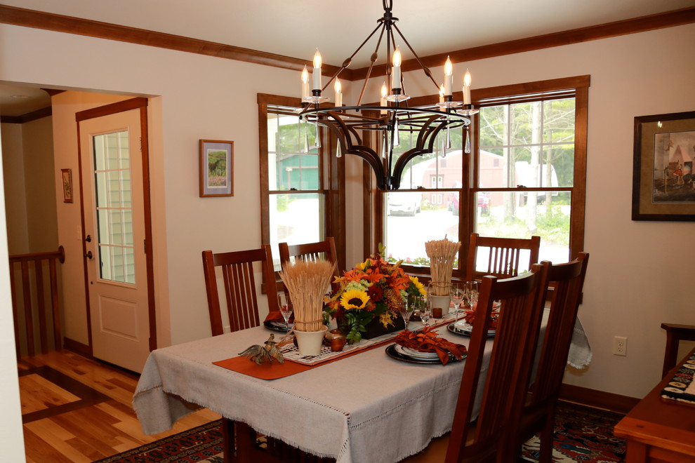 This is an example of an arts and crafts separate dining room in Other with blue walls and light hardwood floors.