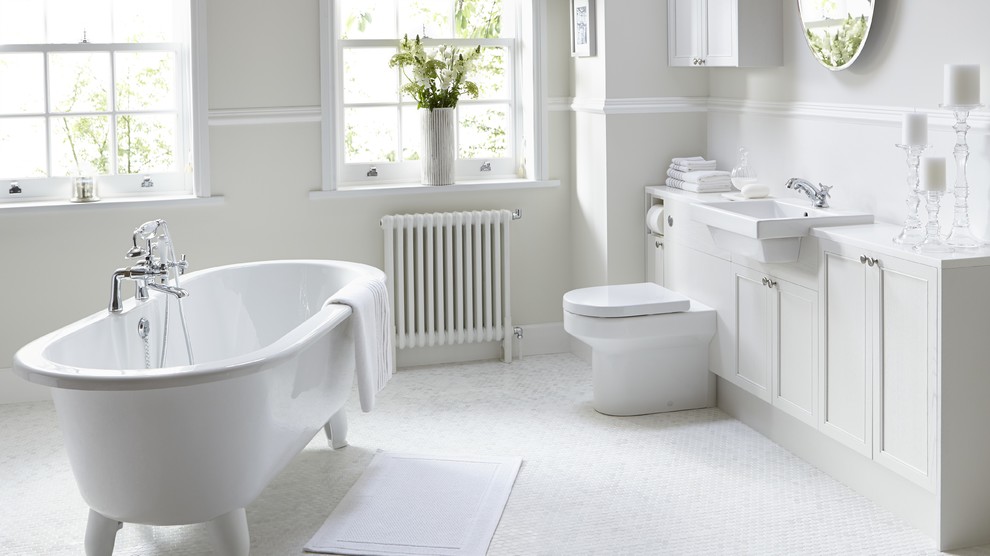 Inspiration for a large contemporary bathroom in Hertfordshire with a drop-in sink, beaded inset cabinets, white cabinets, a claw-foot tub, a one-piece toilet, white tile, white walls and mosaic tile floors.