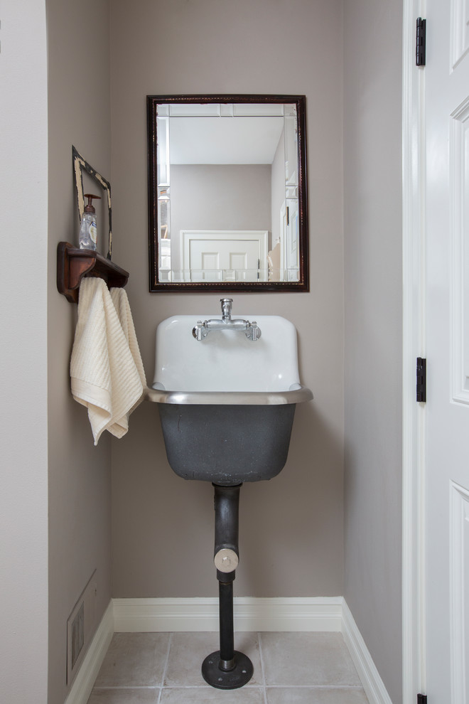 This is an example of a small traditional powder room in Milwaukee with grey walls, ceramic floors, a wall-mount sink and beige floor.