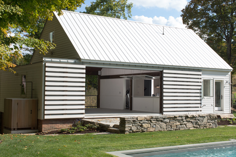 Cottage one-story and detached wood pool photo in New York
