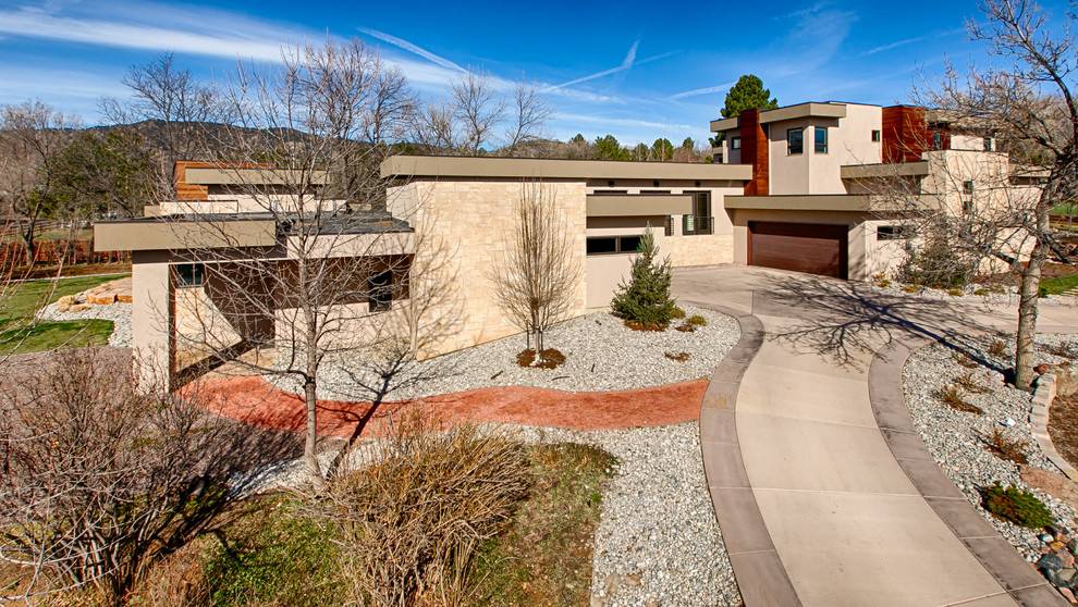 Large contemporary two-storey stucco beige exterior in Denver with a flat roof.