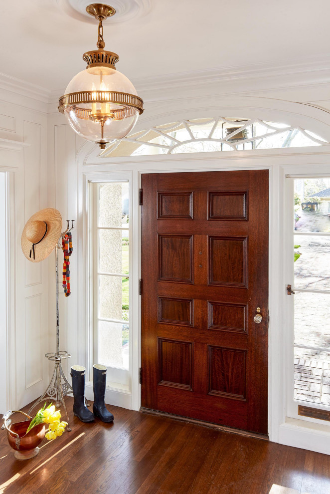 Large traditional foyer in San Francisco with white walls, dark hardwood floors, a single front door, a dark wood front door, brown floor and panelled walls.
