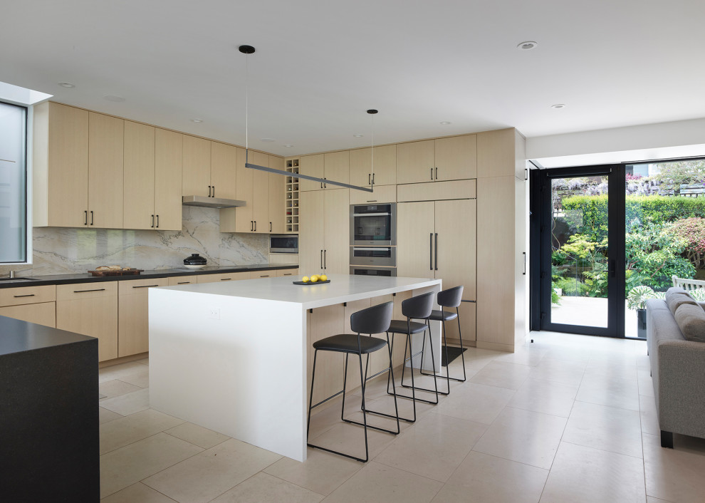 Inspiration for a mid-sized modern u-shaped open plan kitchen in San Francisco with an undermount sink, flat-panel cabinets, light wood cabinets, quartz benchtops, multi-coloured splashback, stone slab splashback, stainless steel appliances, limestone floors, with island, white floor and multi-coloured benchtop.