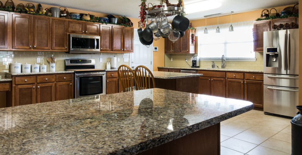 Large l-shaped ceramic tile and beige floor eat-in kitchen photo with an undermount sink, flat-panel cabinets, brown cabinets and an island