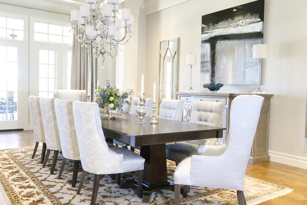 Enclosed dining room - large transitional medium tone wood floor enclosed dining room idea with gray walls and no fireplace
