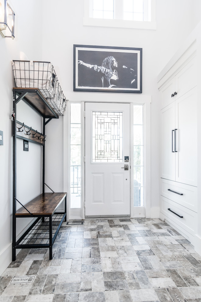 This is an example of a transitional foyer in Toronto with white walls, a single front door, a white front door and grey floor.