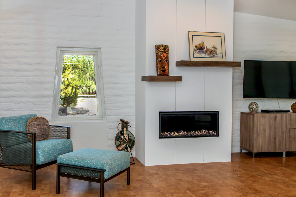 Inspiration for a mid-sized midcentury open concept living room in Phoenix with white walls, cork floors, a ribbon fireplace and a wall-mounted tv.
