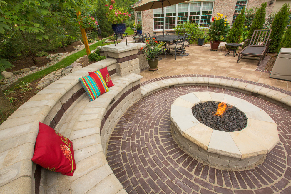 Example of a mid-sized classic backyard concrete paver patio design in Indianapolis with a fire pit