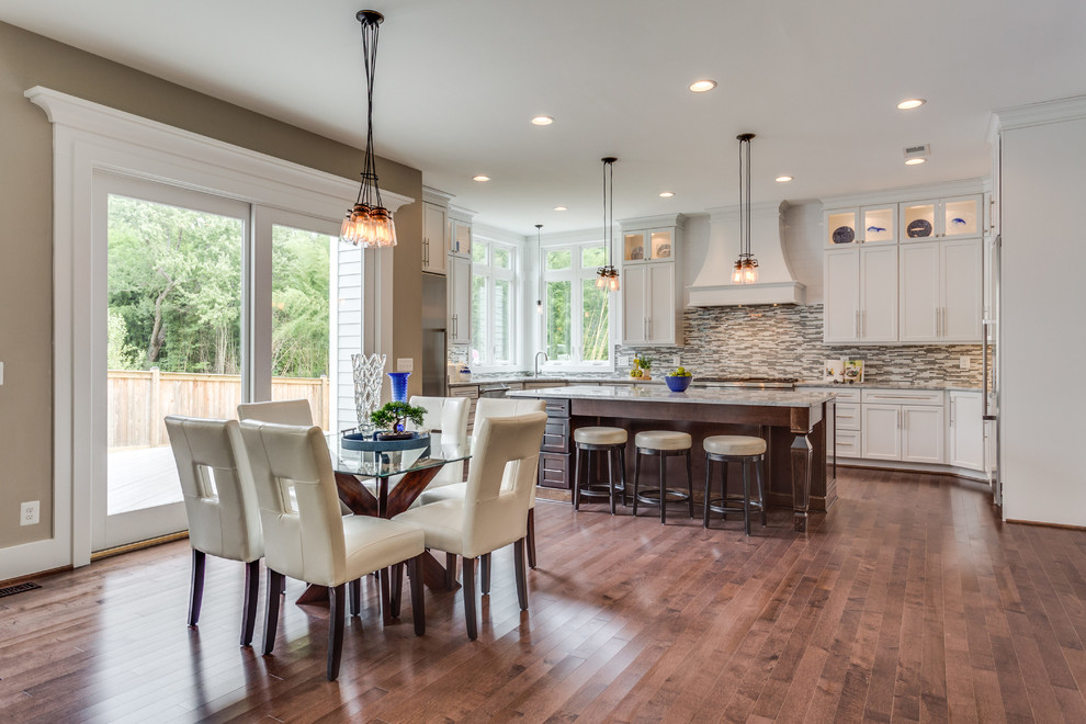 Open concept kitchen - large transitional u-shaped dark wood floor open concept kitchen idea in DC Metro with an undermount sink, shaker cabinets, white cabinets, granite countertops, glass tile backsplash, stainless steel appliances and an island