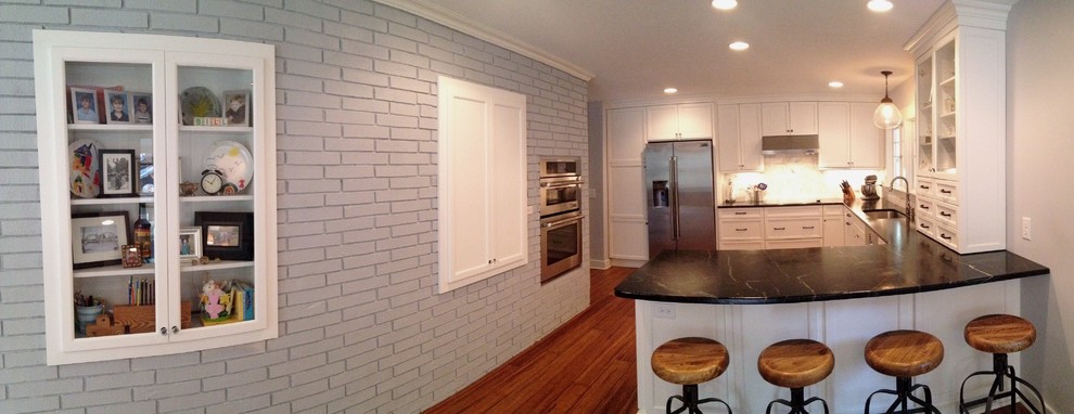 Inspiration for a transitional u-shaped kitchen remodel in Raleigh with shaker cabinets, white cabinets and stainless steel appliances