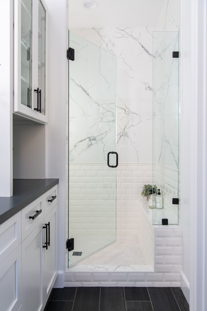 Bathroom - mediterranean porcelain tile, black floor and single-sink bathroom idea in Orange County with white cabinets, white walls, a vessel sink, quartzite countertops, a hinged shower door, black countertops and a built-in vanity