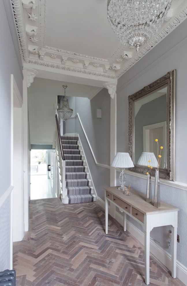 Traditional hallway in Belfast with grey walls and light hardwood floors.