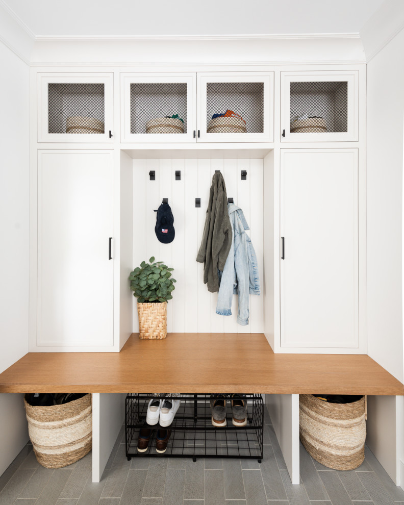 Transitional shiplap wall mudroom photo in New York with white walls