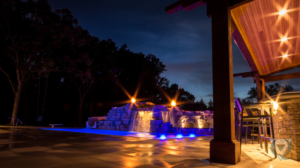 Inspiration for a large rustic backyard stone and rectangular natural pool fountain remodel in Chicago