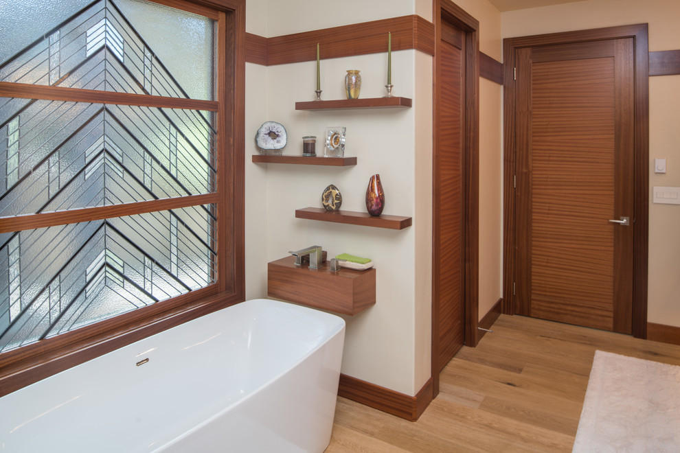 This is an example of a mid-sized contemporary master bathroom in Other with flat-panel cabinets, medium wood cabinets, a freestanding tub, an open shower, a two-piece toilet, ceramic tile, white walls, light hardwood floors, an undermount sink and tile benchtops.