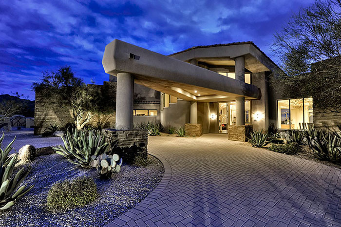 Example of a huge transitional concrete floor front door design in Phoenix with beige walls and a glass front door