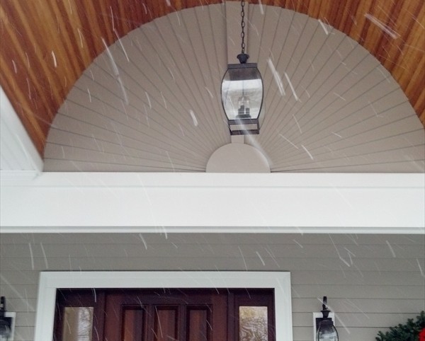 Example of a mid-sized mountain style front door design in Boston with brown walls and a brown front door