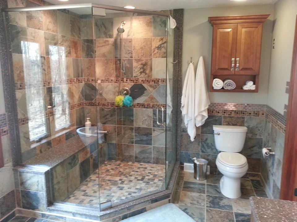 Example of a mid-sized transitional master multicolored tile and porcelain tile porcelain tile freestanding bathtub design in Cleveland with raised-panel cabinets, medium tone wood cabinets, a two-piece toilet, gray walls, an undermount sink and quartz countertops