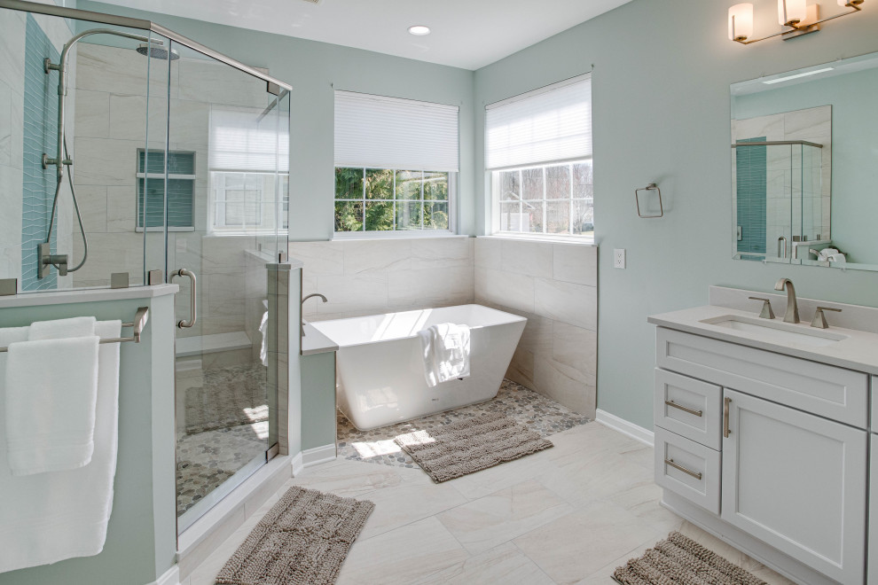 Large classic ensuite bathroom in DC Metro with a freestanding bath, a corner shower, beige tiles, glass tiles, a submerged sink, engineered stone worktops, a hinged door, a wall niche, double sinks and a built in vanity unit.
