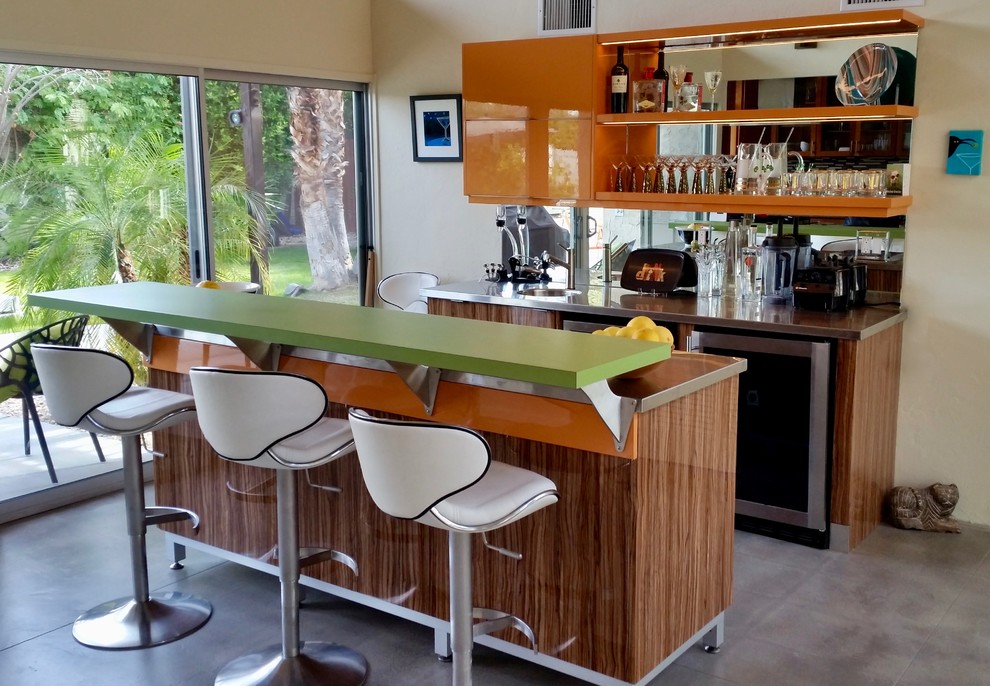 Photo of a mid-sized midcentury single-wall seated home bar in Other with an integrated sink, flat-panel cabinets, medium wood cabinets, laminate benchtops and mirror splashback.