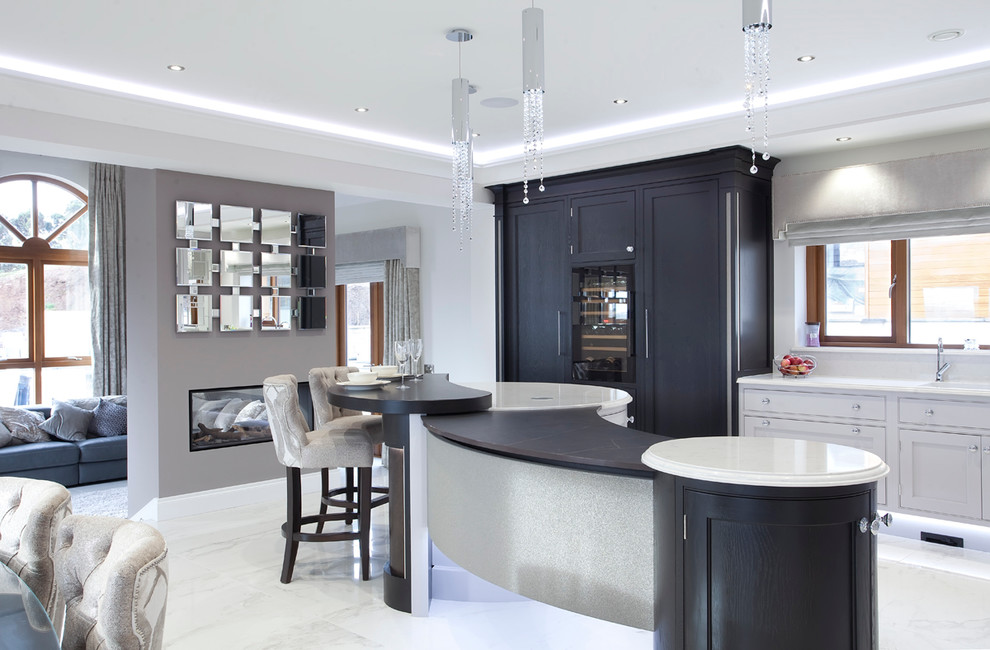 This is an example of a mid-sized contemporary l-shaped open plan kitchen in Surrey with an integrated sink, beaded inset cabinets, grey cabinets, quartzite benchtops, white splashback, stone slab splashback, stainless steel appliances, marble floors and with island.