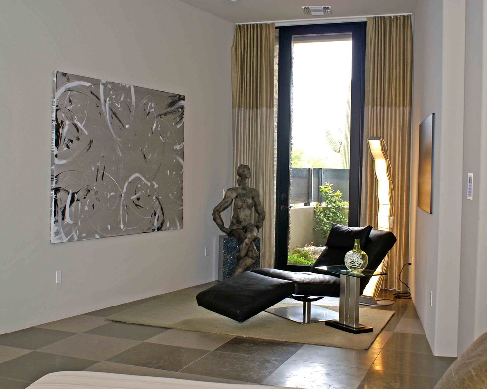 Photo of a large contemporary master bedroom in Phoenix with grey walls and limestone floors.