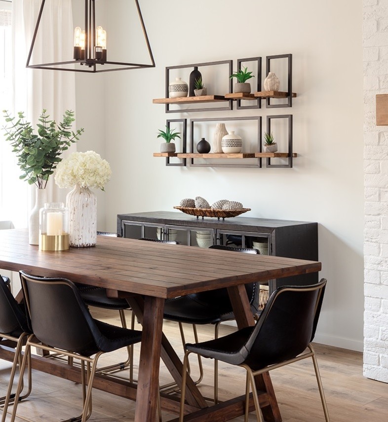 Small country open plan dining in Vancouver with white walls, laminate floors, a standard fireplace and a brick fireplace surround.