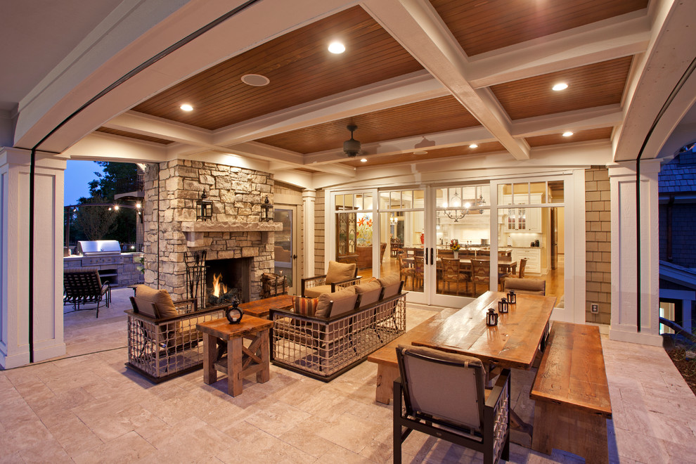 Inspiration for a traditional verandah in Minneapolis with a fire feature and a roof extension.
