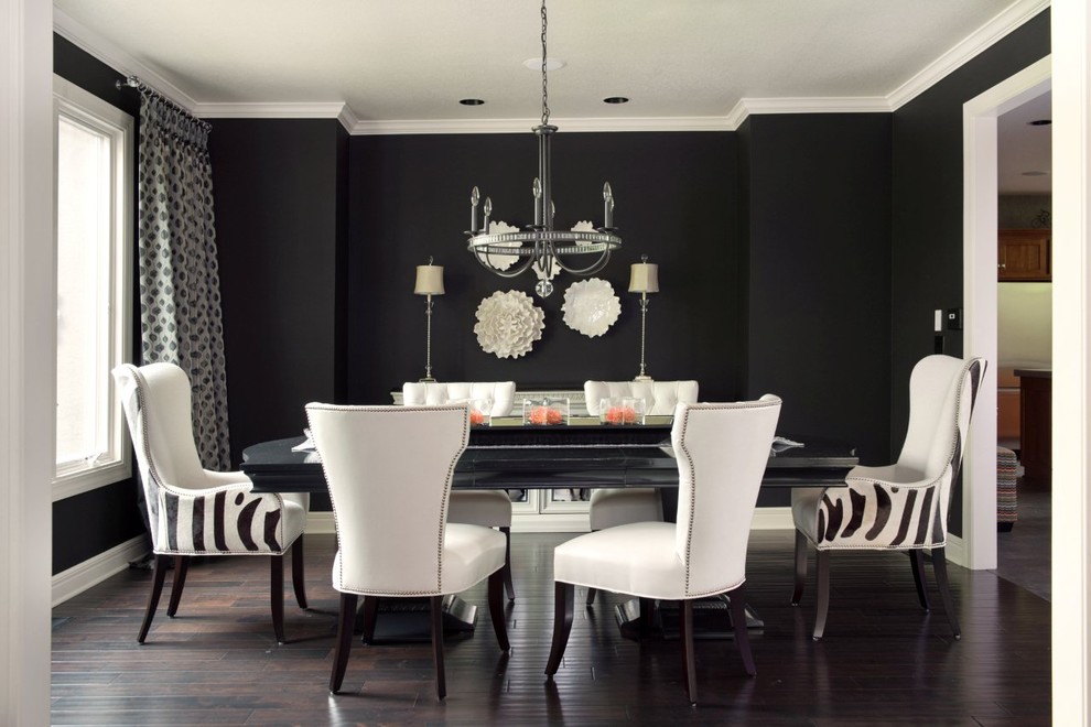 This is an example of a transitional dining room in Kansas City with black walls, dark hardwood floors and brown floor.