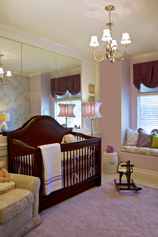 Photo of a traditional nursery for girls in Orange County with purple walls, carpet and purple floor.