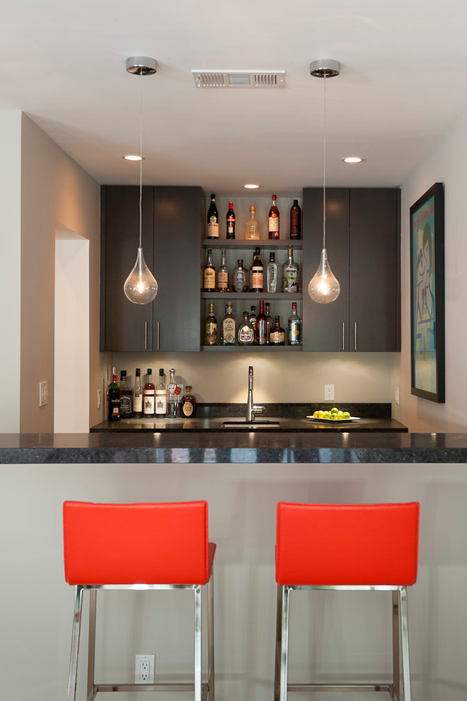 Photo of a contemporary galley seated home bar in San Francisco with flat-panel cabinets and dark wood cabinets.