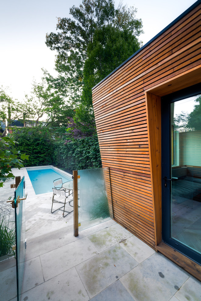Inspiration for a mid-sized modern backyard stone and rectangular pool remodel