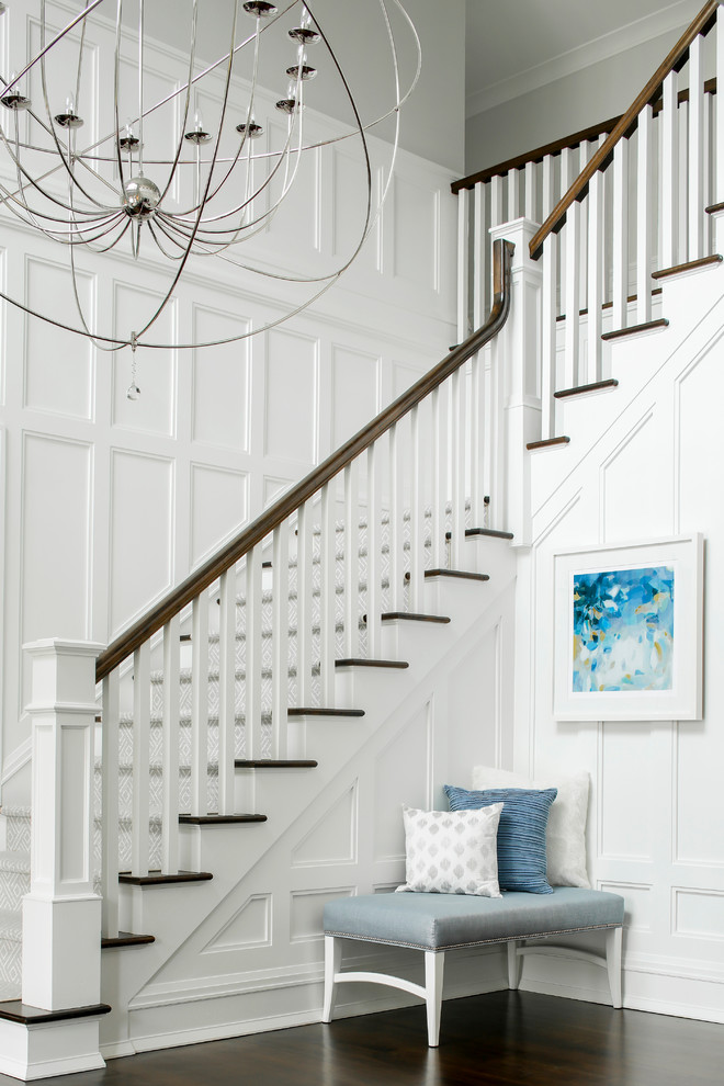Inspiration for a large traditional foyer in New York with white walls, dark hardwood floors, a single front door and a dark wood front door.