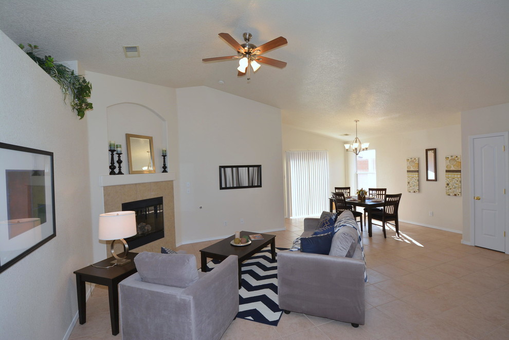 Photo of a large contemporary open concept living room in Albuquerque with beige walls, ceramic floors, a corner fireplace, a tile fireplace surround and a wall-mounted tv.