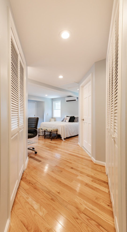 Photo of a large contemporary master bedroom in DC Metro with grey walls, light hardwood floors, no fireplace and brown floor.