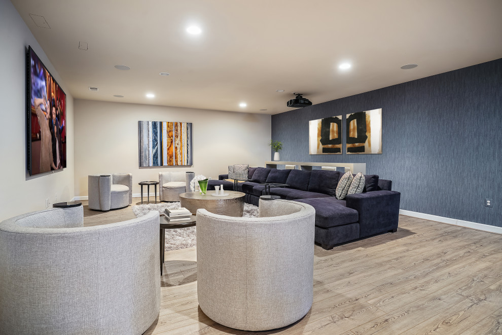 Design ideas for a medium sized contemporary basement in DC Metro with a home cinema, blue walls, light hardwood flooring and wallpapered walls.